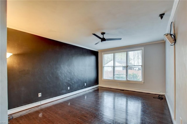 spare room featuring ceiling fan, ornamental molding, and dark hardwood / wood-style floors