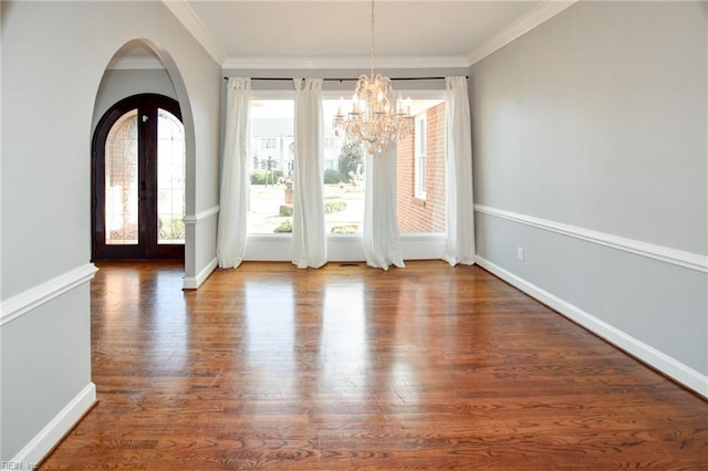 unfurnished dining area featuring french doors, ornamental molding, and hardwood / wood-style floors