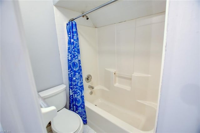 bathroom with toilet and shower / bath combo with shower curtain