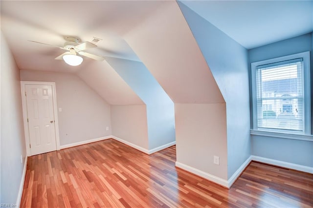 bonus room with wood-type flooring, lofted ceiling, and ceiling fan