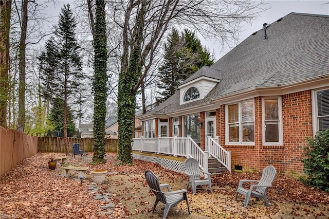 back of property featuring a wooden deck