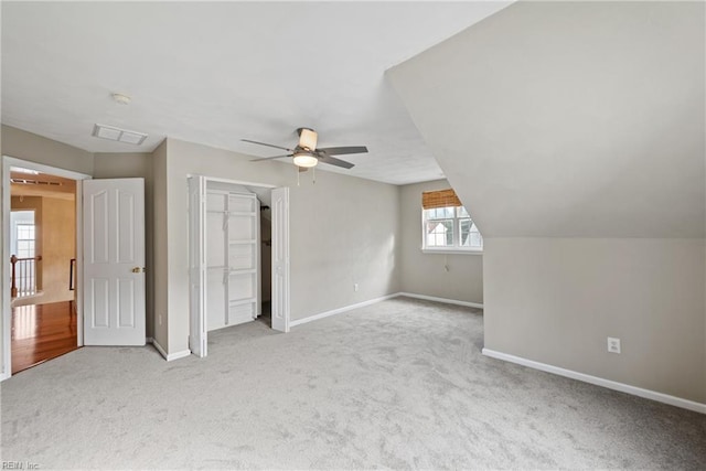 unfurnished bedroom featuring carpet, a closet, ceiling fan, and baseboards