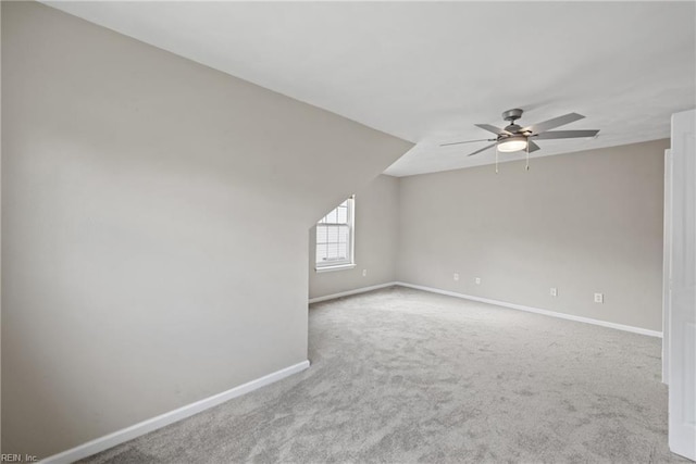 spare room featuring ceiling fan, baseboards, and carpet flooring