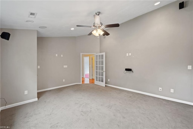 empty room featuring ceiling fan, carpet, visible vents, and baseboards