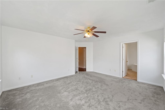 unfurnished room featuring light colored carpet, ceiling fan, and baseboards