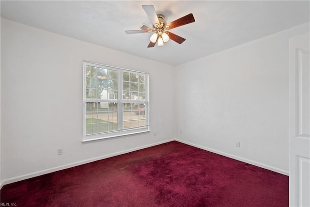 carpeted empty room featuring ceiling fan and baseboards