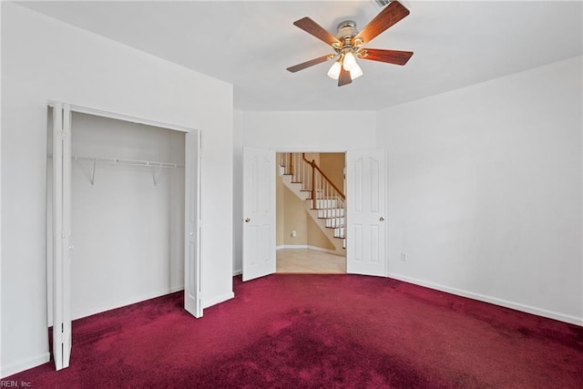 unfurnished bedroom with a ceiling fan, carpet, baseboards, and a closet