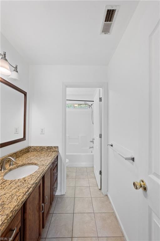 full bath featuring tile patterned flooring, toilet, vanity, visible vents, and washtub / shower combination