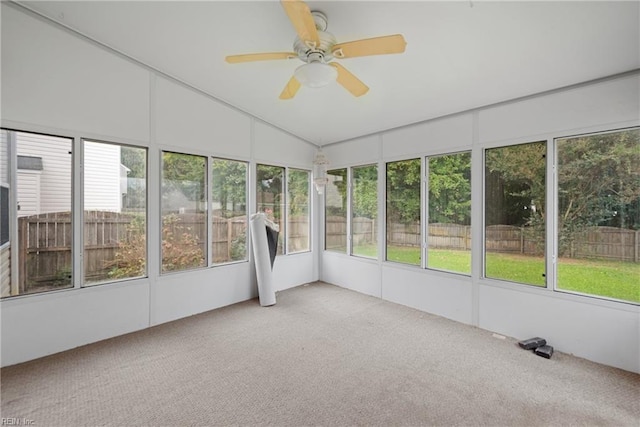 unfurnished sunroom with vaulted ceiling and ceiling fan