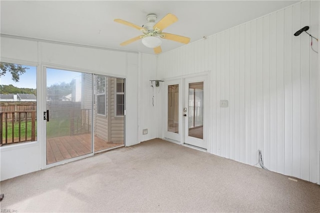 unfurnished room with a ceiling fan and light carpet