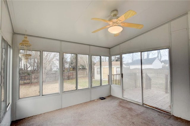 unfurnished sunroom with a ceiling fan and lofted ceiling