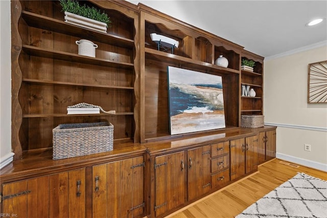 interior space featuring crown molding and hardwood / wood-style floors