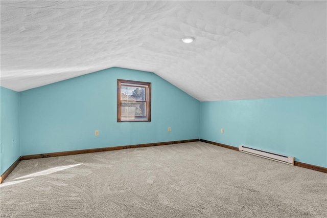 bonus room with a baseboard radiator, vaulted ceiling, carpet floors, and a textured ceiling