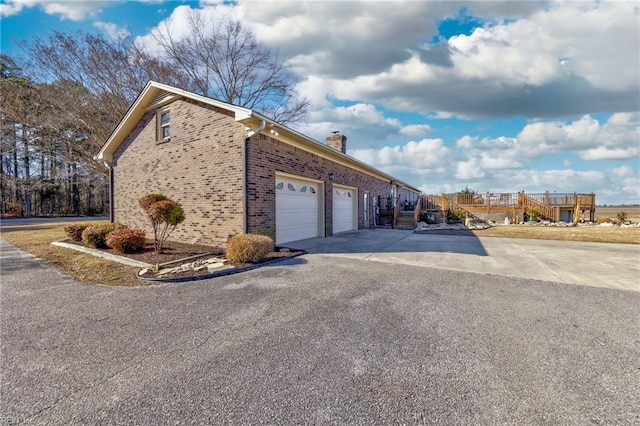 view of side of home with a garage