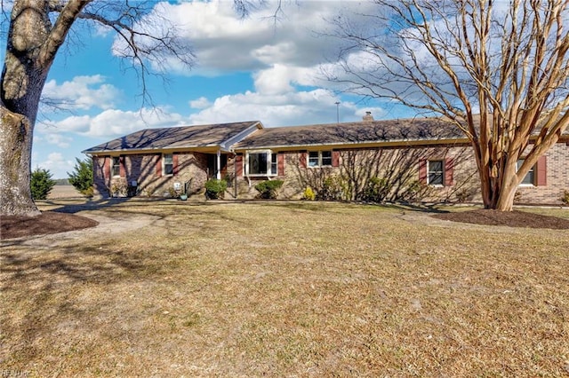 ranch-style home with a front lawn