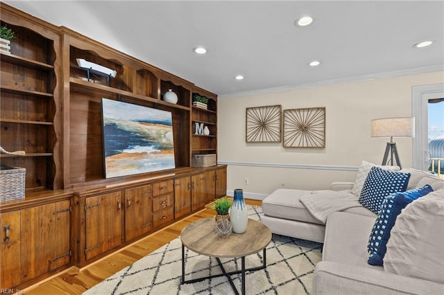 living room featuring ornamental molding and light hardwood / wood-style floors