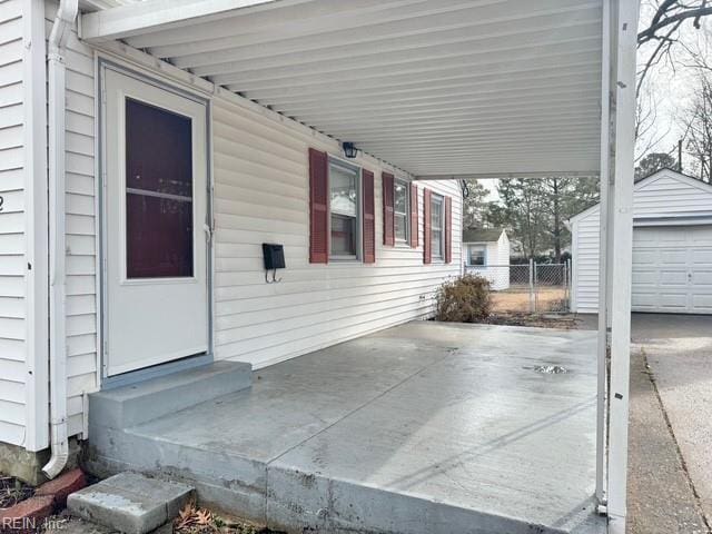 view of patio / terrace featuring a garage and an outdoor structure