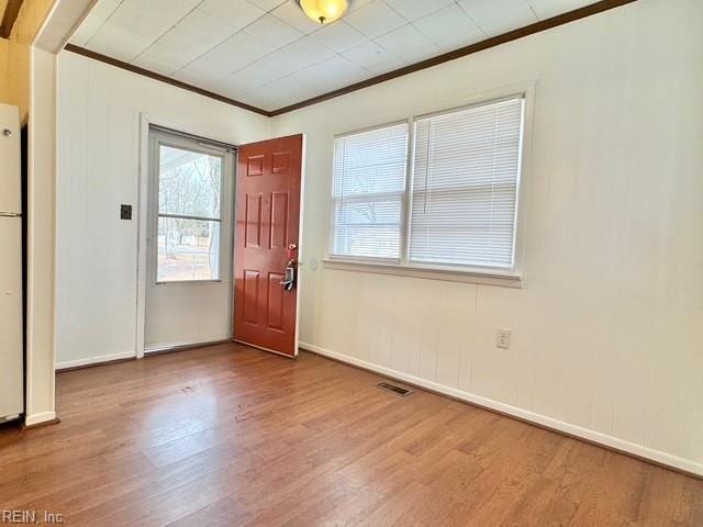 entryway featuring hardwood / wood-style flooring and crown molding