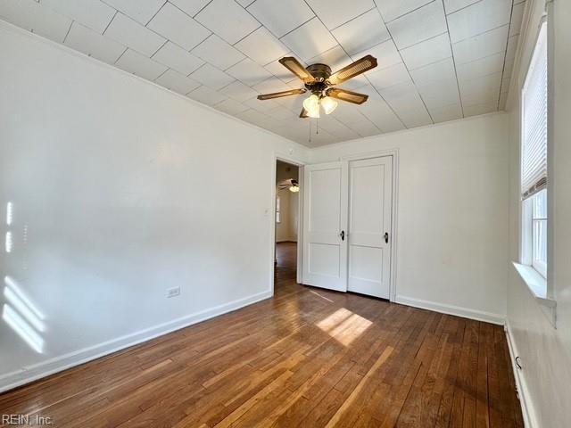 unfurnished bedroom featuring dark hardwood / wood-style floors and ceiling fan