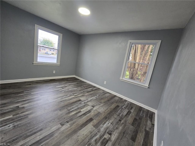 spare room with dark wood-type flooring