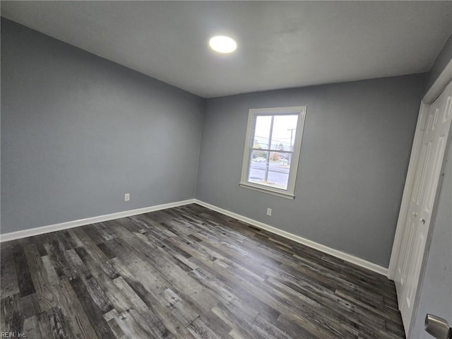 unfurnished bedroom featuring dark hardwood / wood-style floors and a closet