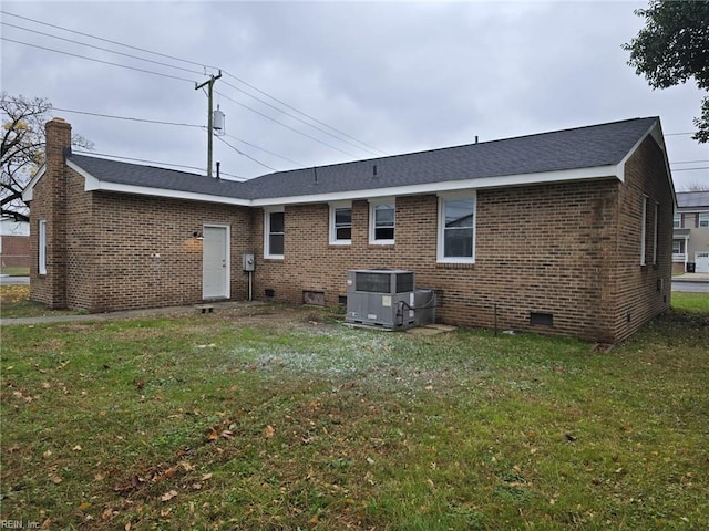 back of property featuring a yard and central AC unit