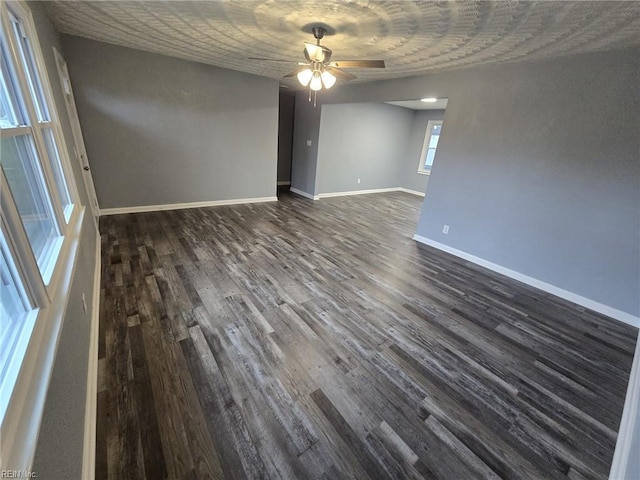 unfurnished room with dark hardwood / wood-style floors and ceiling fan