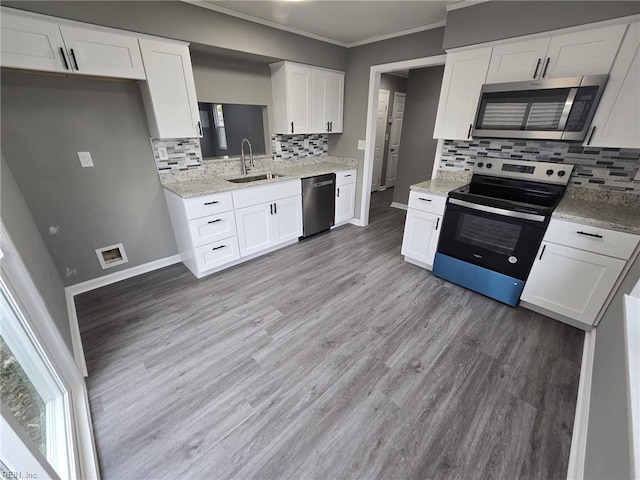 kitchen featuring stainless steel appliances, white cabinetry, and sink