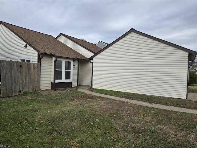 view of side of property with a lawn