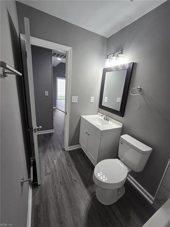 bathroom featuring hardwood / wood-style flooring, vanity, and toilet