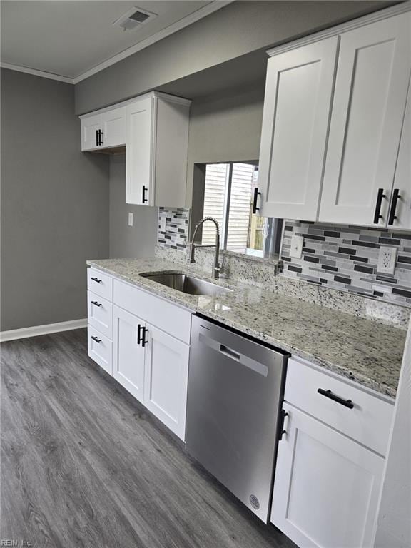 kitchen with sink, crown molding, dishwasher, white cabinetry, and light stone counters