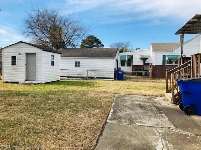 view of yard featuring a patio and a storage shed