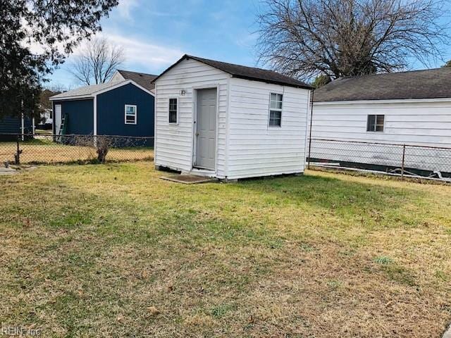 view of outbuilding with a yard