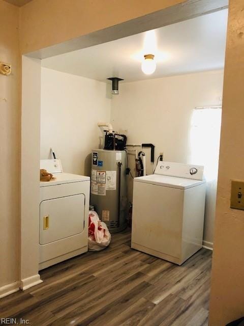 laundry area with dark hardwood / wood-style flooring, separate washer and dryer, and water heater