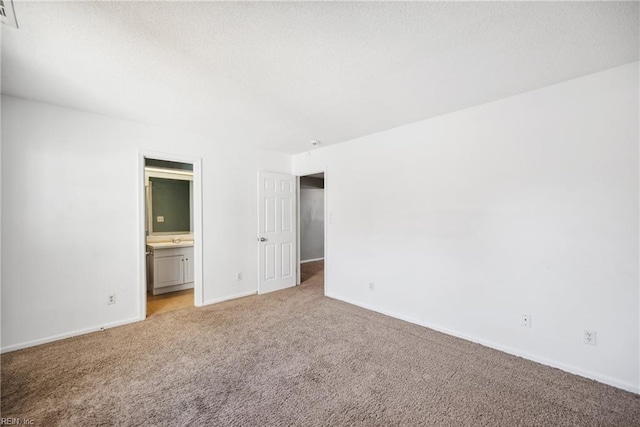 carpeted spare room featuring sink