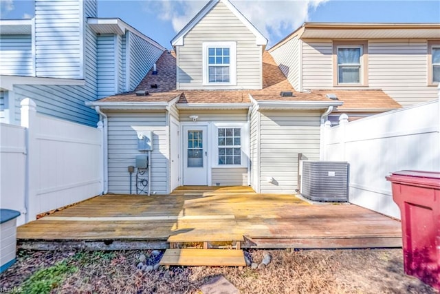 rear view of property featuring a wooden deck and central air condition unit