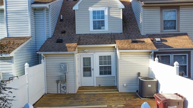 rear view of property with cooling unit and a deck