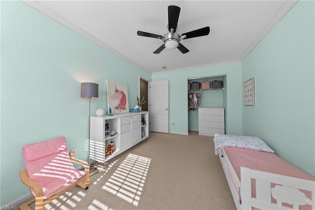 bedroom with ceiling fan, a closet, ornamental molding, and light carpet