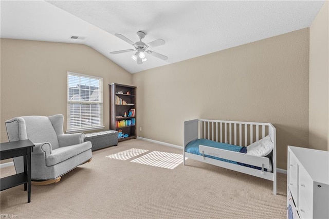 bedroom with ceiling fan, light colored carpet, and lofted ceiling