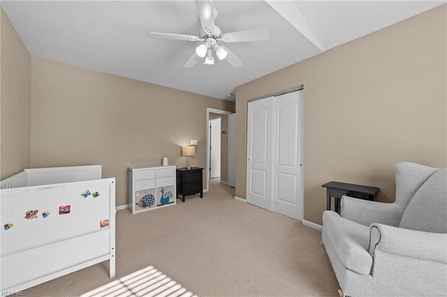 carpeted bedroom featuring a closet and ceiling fan