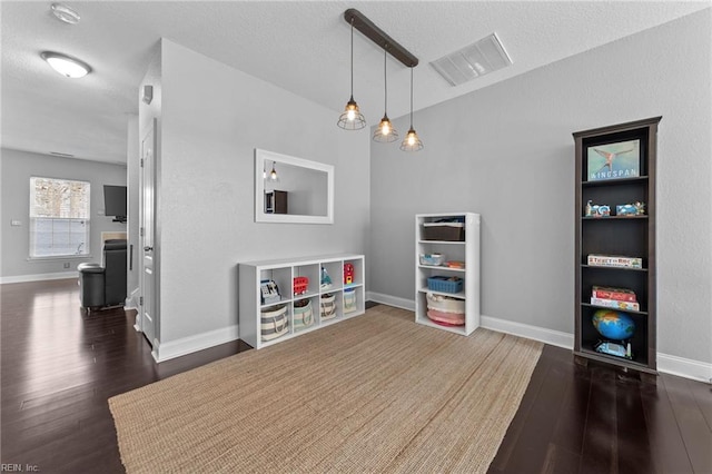 game room with dark wood-type flooring