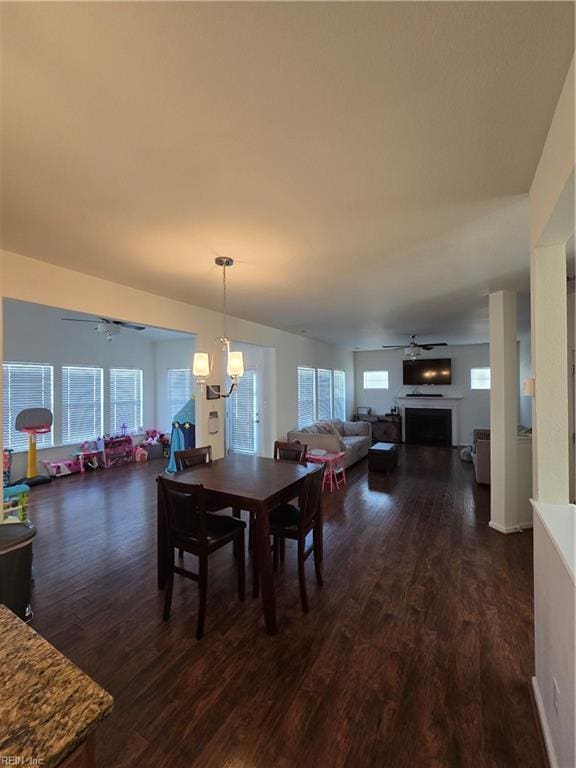 dining space with dark wood-type flooring and ceiling fan