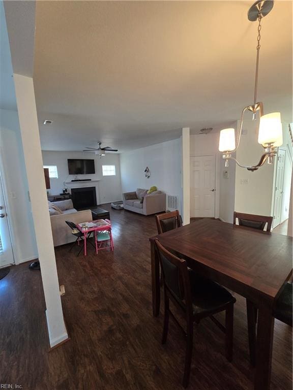 dining space featuring ceiling fan and dark hardwood / wood-style flooring