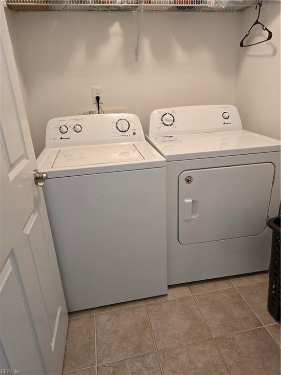 laundry room with separate washer and dryer and light tile patterned floors