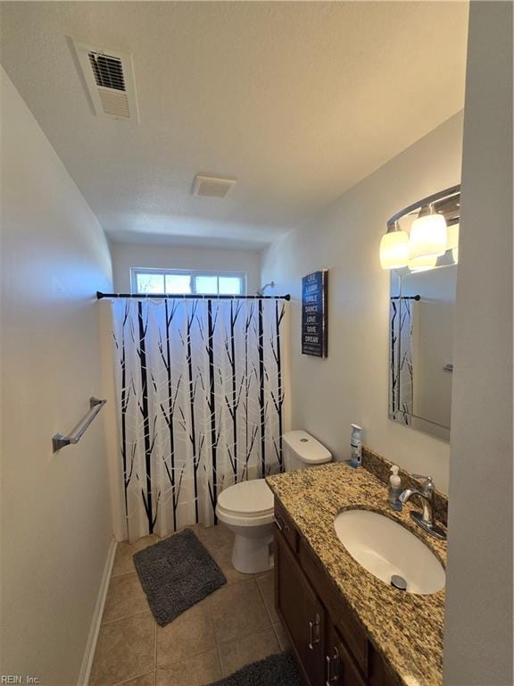 bathroom with a shower with curtain, vanity, toilet, and tile patterned flooring