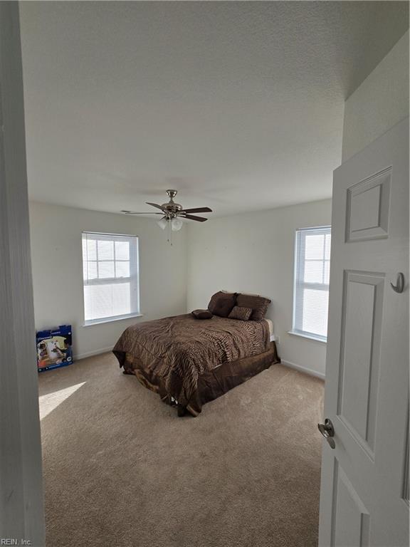 carpeted bedroom with ceiling fan