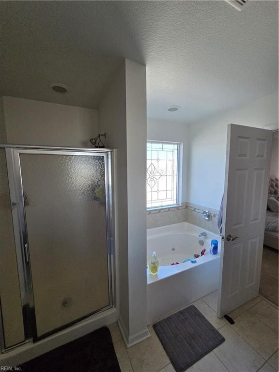 bathroom with independent shower and bath, tile patterned flooring, and a textured ceiling