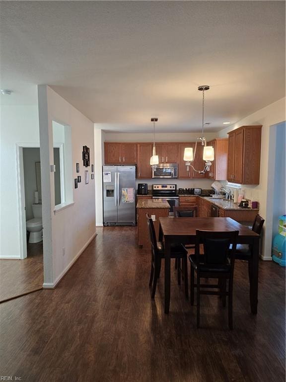 dining area featuring dark wood-type flooring and sink