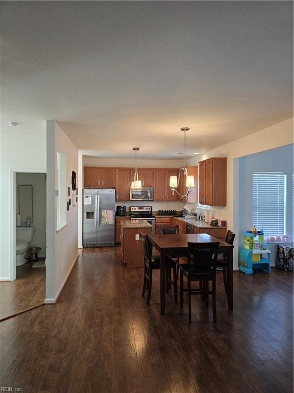 dining area featuring dark wood-type flooring