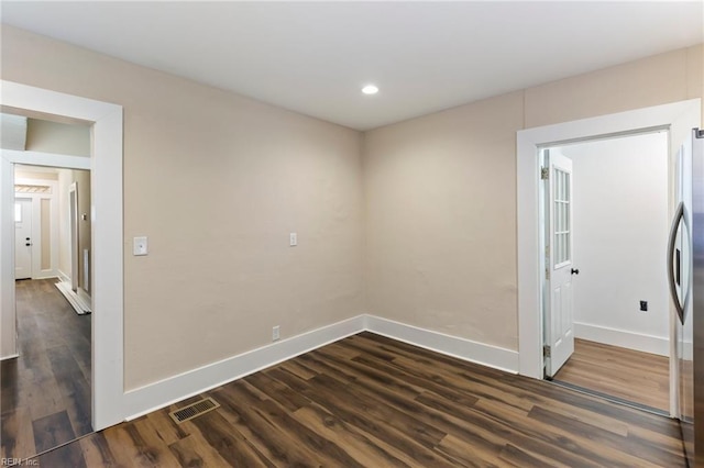 unfurnished room with dark hardwood / wood-style flooring